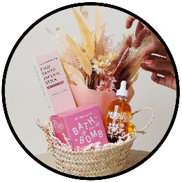 basket with decorative dried plants, skincare and a bath bomb